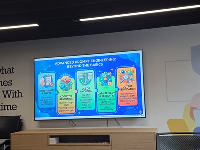 Large digital screen showing a colourful presentation slide