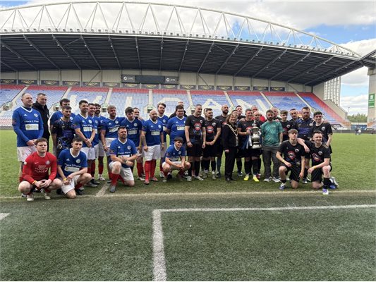Group of men inside a football stadium