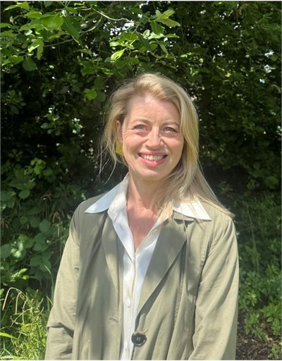 Kate Brindley stood in front of woodland