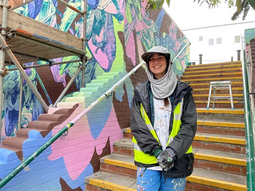 George Rose at her mural next to the steps at Greensway shopping centre