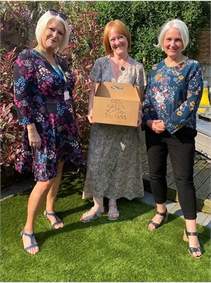 Julie Brown and Anna Lomas from Wigan Council present foster carer Deb Clayton with her hamper