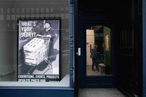 Shop front showing a poster asking 'What's your story?'