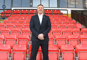 A man standing at Wigan Warriors stadium