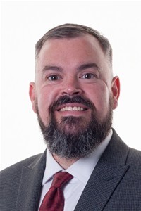 Man with a beard wearing a red tie