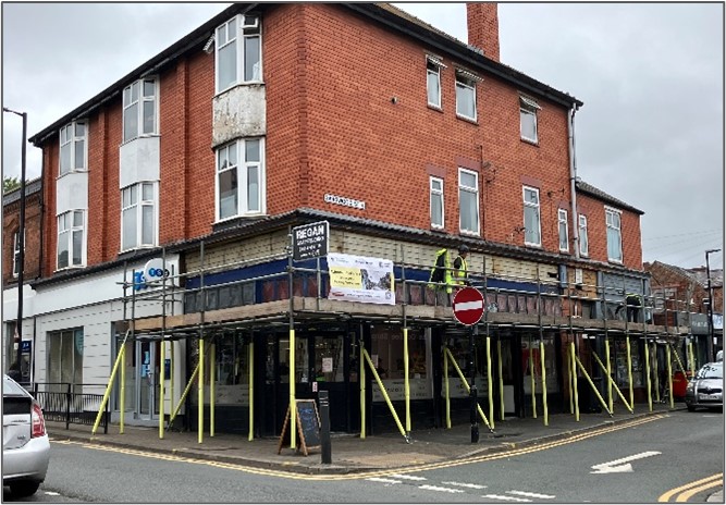 Scaffolding on 64 Gerard street. Three storey building on the corner of a road.