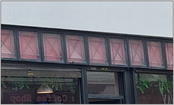 A row of horizontal windows across the top of the building