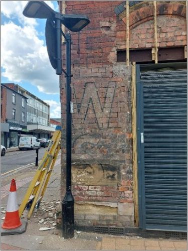 EWS faded initials on the inner brickwork of a building
