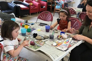 Children taking part in painting activities at the Beehive Community Centre