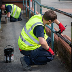 Painting railings in Aspull