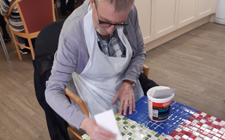 Dennis tiling the garden table