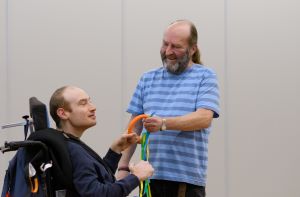 Support workers with disabled person holding a hoola hoop