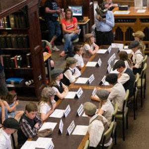 Class of school children using a museum gallery for a workshop session