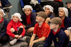 Group of school children wearing old fashioned hats